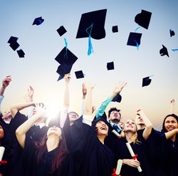 graduates throwing their caps